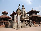 Kathmandu Bhaktapur 02-1 Bhaktapur Durbar Square Teleju Bell, King Bhupatindra Malla Column, And Vatsala Durga Temple In front of the Royal Palace in Bhaktapur�s Durbar Square are the large Teleju Bell (1737), King Bhupatindra Malla�s column (1699), and the shikhara-style stone Vatsala Durga Temple (1672). Much of Bernardo Bertolucci�s movie Little Buddha was filmed near the Vatsala Temple. On the left is Chyasilin Mandapam, an octagonal temple rebuilt in 1990 after it was destroyed by fire in 1934.